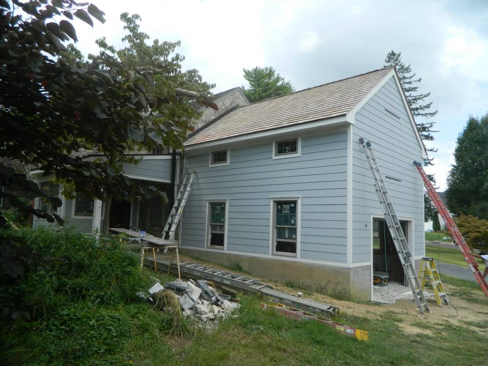 Sehnco home addition under construction with siding, windows and a new foundation